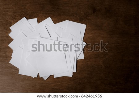 Stack of a blank business card on a dark wooden background. View from above. Layout for creating a corporate identity. Mockup of business cards fan stack on a dark wooden background. Business concept.