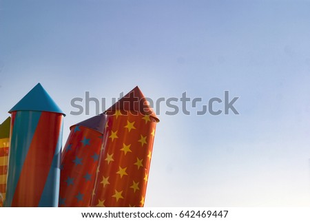 Large festive bright fireworks, rockets against the blue sky with empty, free space for summer postcards, positive advertising, design, congratulations on birthday, advertising of children's toys.