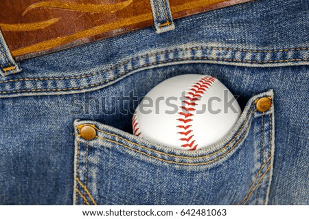 A baseball ball in a pocket of old legendary jeans