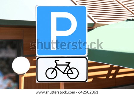 Bicycle parking sign in front of building