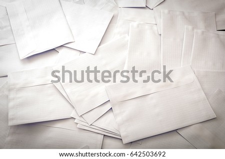 Spam mail and correspondence delivery concept big pile of blank scattered envelopes with copy space on one envelope in the bottom right corner