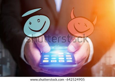 View of Hand drawn angel and demon icon going out a smartphone interface of a businessman at the office - Business concept