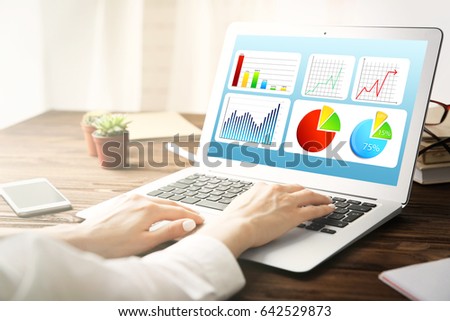 Marketing concept. Woman working with laptop in office. Schedule of income and business information on screen