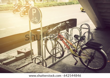 Bicycle parked on the bike parking under overpass near road
