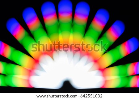 The blur of many colored lights overlaps the background.
