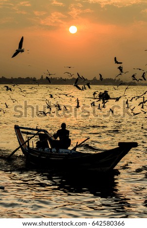 Silhouette of life style in Yangon river sunset.