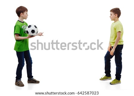 little boys playing soccer isolated in white