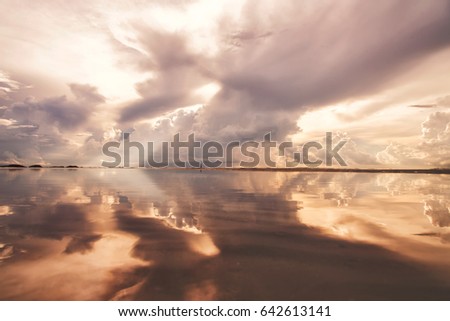 Sunlight on the beach in the morning with cloudy refection on the sea background wallpaper