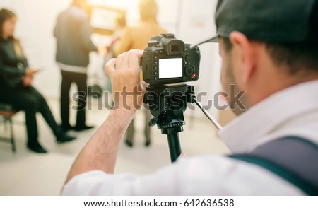 The videographer works, makes a video report Royalty-Free Stock Photo #642636538