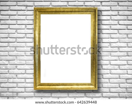 Gold frame on white brick wall.
