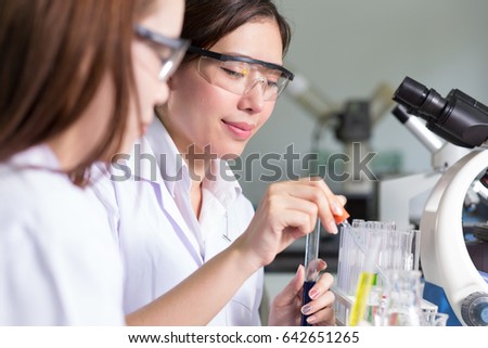 Young medical technicians working in laboratory,soft focus