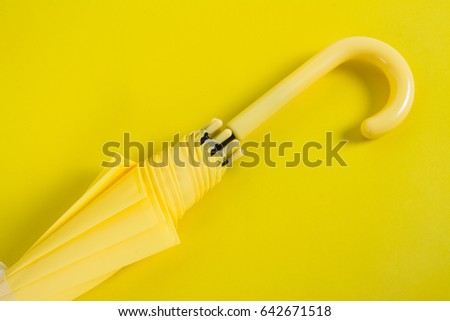 A yellow umbrella on background yellow