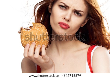 A woman with a burger, a woman took a bite