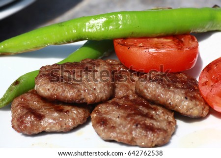 Delicious Turkish Traditional Kebab Kofte with grilled tomato on white plate (meatballs) Royalty-Free Stock Photo #642762538