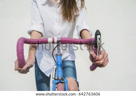 no face. A young girl rides her bike, hands on the wheel closeup. isolated on white texture background. empty copy space for object or inscription. 