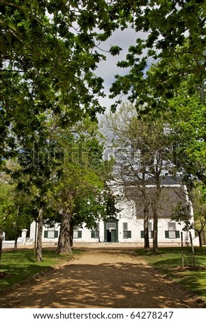 The manor house at Groot Constantia, the oldest and most historic of South Africa's wine farms. Royalty-Free Stock Photo #64278247