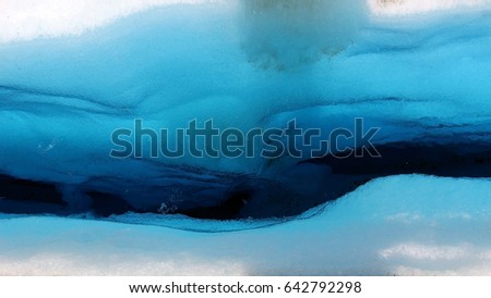 Almost abstract picture of a deep blue crevasse in the ice filled with water on Perito Moreno glaciar
