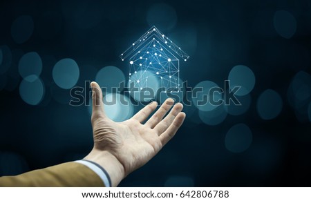 house on virtual screen in man hand