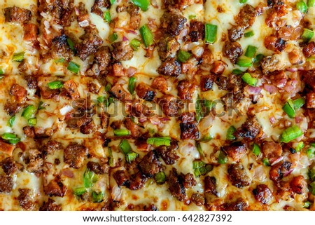 Square pizza with meat and cheese.