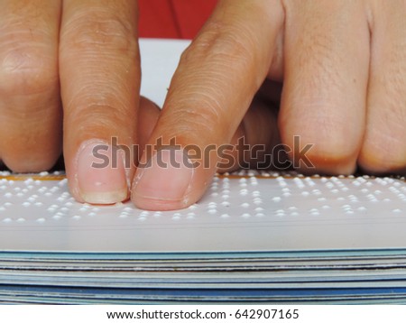 Close up finger touch to braille code,reading braille alphabet in book.          