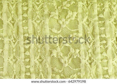 Green Crochet lace dress material cloth texture pattern. 
tailoring stitching concept. Shiny beautiful fashion fabric. Shiny clothing material sample.Creased fabric.