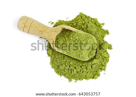 Moringa oleifera powder with wooden scoop isolated on white background. Top view Royalty-Free Stock Photo #643053757