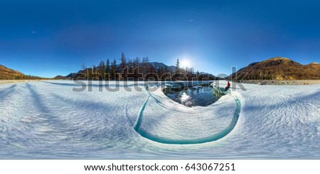 Spherical 360 180 degrees panorama of a man on an ice melting river. Royalty-Free Stock Photo #643067251