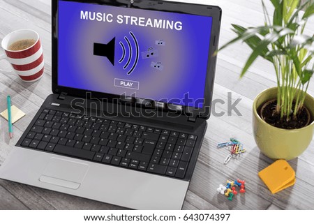 Laptop on a desk with music streaming concept on the screen