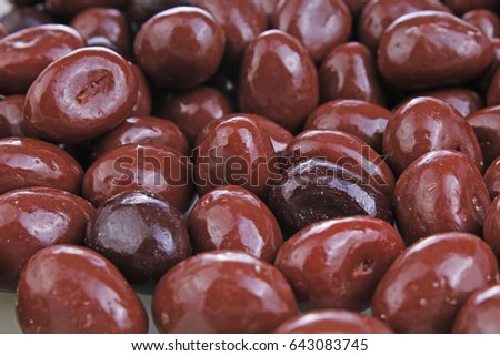 
Dark and dairy chocolate balls.  Chocolate drops as background texture pattern. Bonbons.