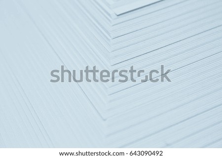 Thin sheets of paper overlap several sheets.