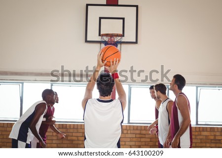 Basketball player about to take a penalty shot while playing basketball in the court