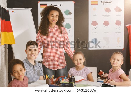Happy kids with young teacher in language school/Happy kids in language school/Sunny, partly cloudy, cloudy, rainy, snowy, sleeting, icy, tornado, thumde