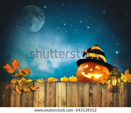 Halloween pumpkin head jack lantern on wooden fence