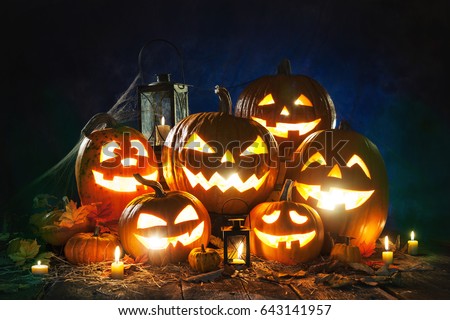 Halloween pumpkin head jack lantern with burning candles Royalty-Free Stock Photo #643141957