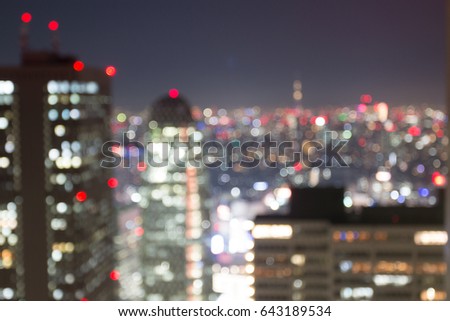 colorful blur Bokeh of the Shinjuku and Tokyo tower at night, view through glass from Metropolitan Government Building observation Royalty-Free Stock Photo #643189534