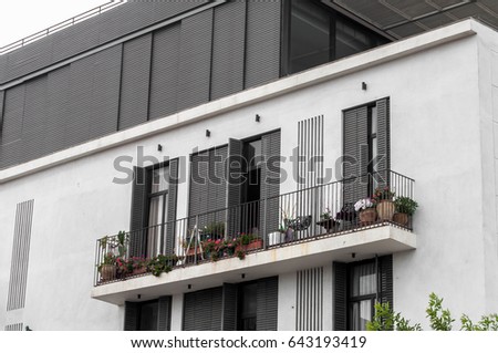 Balconies modern new building with a white stucco and black windows. New Metal Black balconies in a modern style. Modern multistory house. 