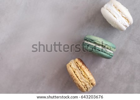Colorful assorted french macaroons on a gray concrete background.  Close up 