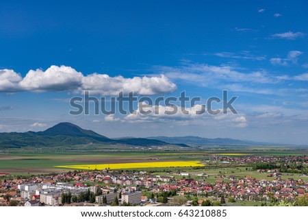 Spring view over Rasnov city, in Brasov county (Romania), with Codlea mountain in the background and with Cristian village in the far right