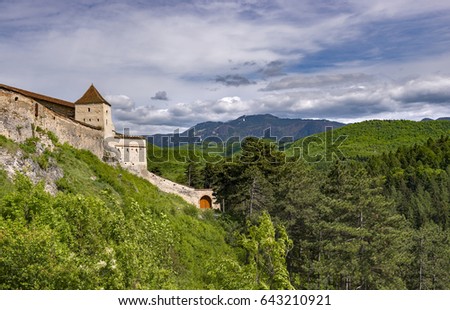 Beautiful spring view of the entrance in the Rasnov citadel in Brasov county (Romania), with Postavaru mountains in the background