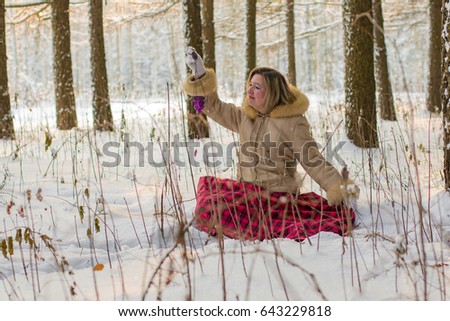 Woman in the forest in a sunny winter day