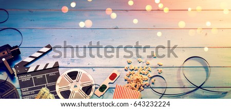 Cinema Film Background - Vintage Effect And Filtered - Camera With Clapperboard, Tickets, Rolls, Glasses And Popcorn
 Royalty-Free Stock Photo #643232224