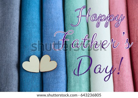 Happy Father's Day postcard with textile colorful palette and two wooden hearts. Text, happy father's day. 