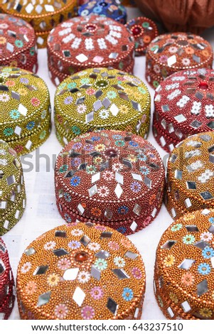 Colourful  Indian Lac Boxes / Traditional Rajasthani Small Jewelry Box decorated with Mirror, Beads, displayed for sale in a street shop Udaipur, Rajasthan India. Royalty-Free Stock Photo #643237510