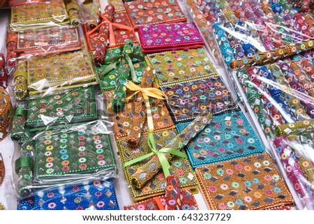 Colourful decorated diary /  book and pen with mirror and bead work displayed in a street shop for sale in Udaipur, Rajasthan India. Gift for kids
 Royalty-Free Stock Photo #643237729