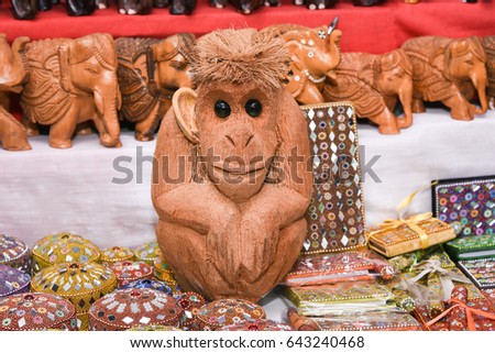 Statue of monkey doll made of dried coconut shell, made from coconut in Kerala stall in market in Delhi India. Displayed for sale. Royalty-Free Stock Photo #643240468