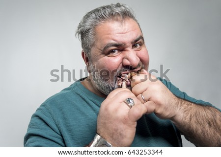 fat man eating meat