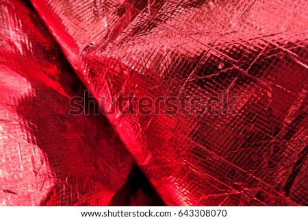 Creased plastic red polyethylene film texture