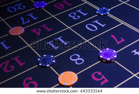 Detail of casino roulette numbers with colored chips Royalty-Free Stock Photo #643333564
