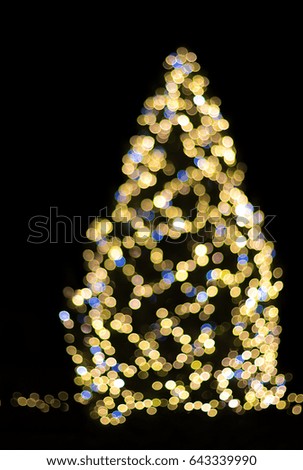 Bokeh picture of a Christmas tree at night with black copy space