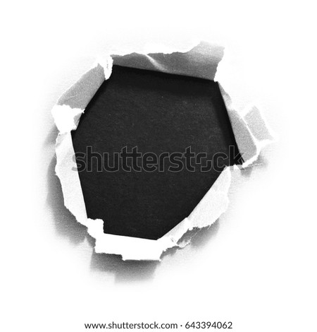 Sheet of paper with a hole against black background isolated on white